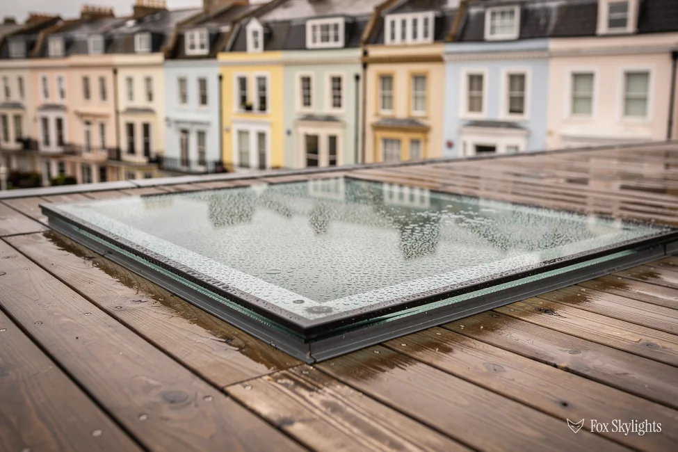 Rain beaded walk on glass panel set into timber decking