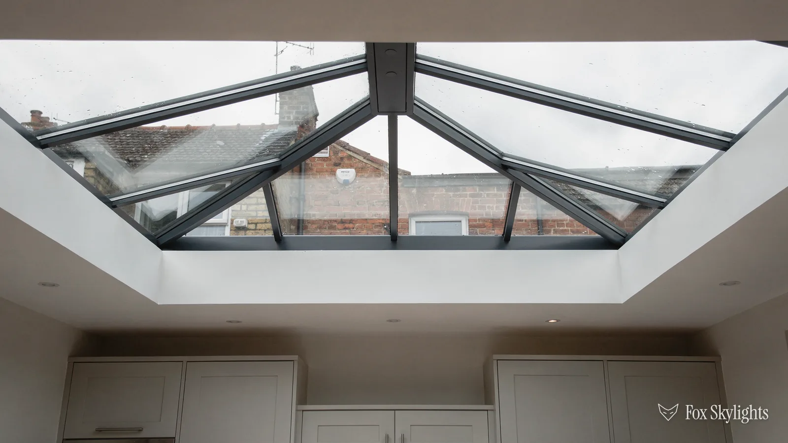 Roof lantern seen from below over a run of white kitchen units