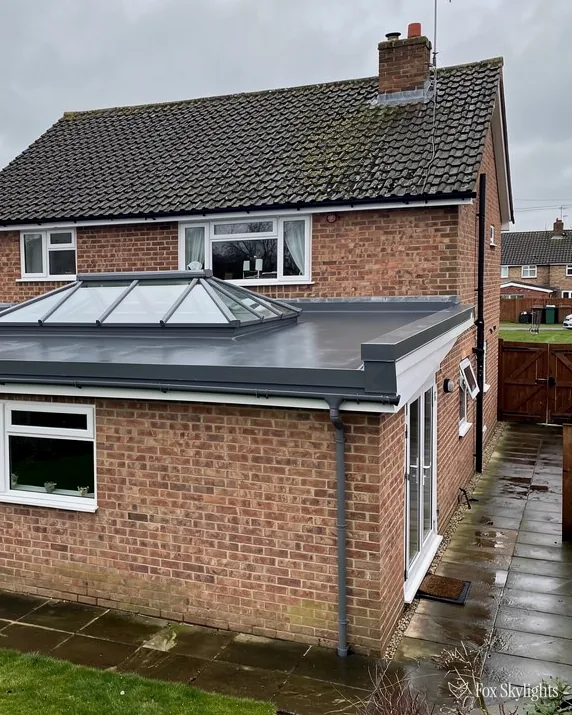 Brick semi with a roof lantern on its flat roof rear extension and wet patio